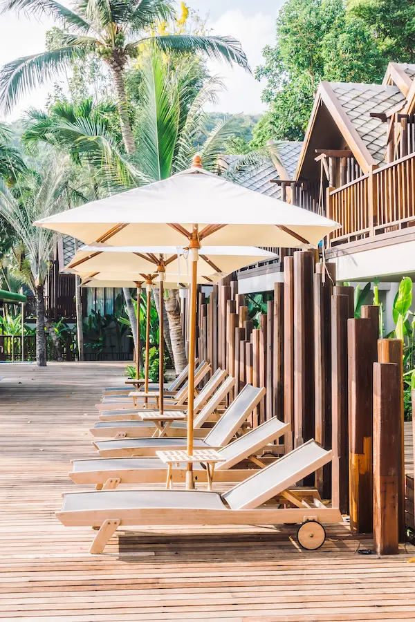 Outdoor deck with sun loungers and umbrellas - perfect for relaxing - Guide to Outdoor Deck Construction